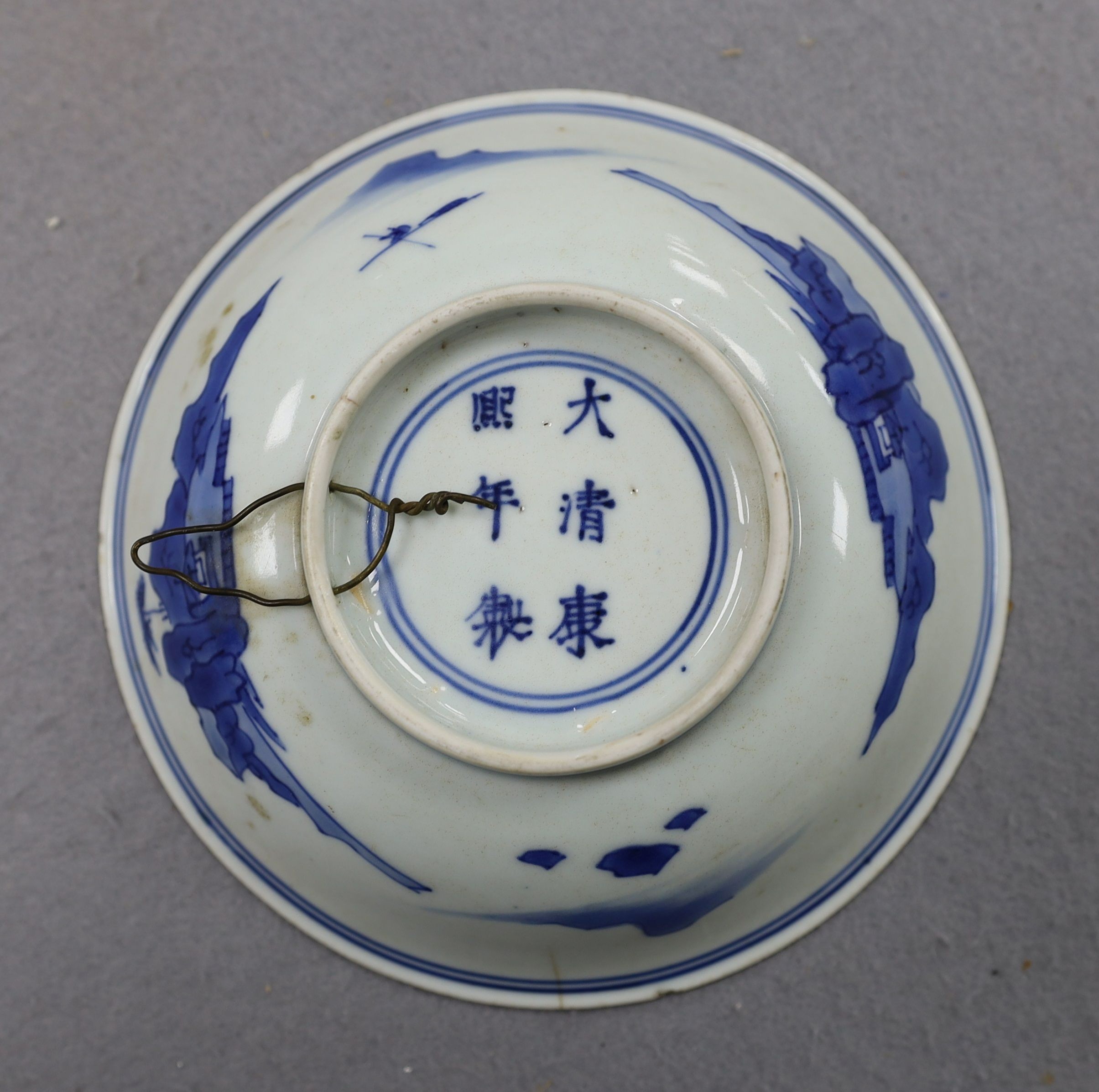 NB BOTH WITH HAIRLINE CRACKS A pair of Chinese blue and white small dishes, Kangxi six character marks and of the period (1662-1722), 15.7cm and 15.8cm diameter, foot later pierced, hairline cracks